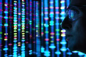 Genetic Research, a closeup of a male scientist viewing DNA information on a wide computer screen screens with blue, red , yellow and green colour representing different data