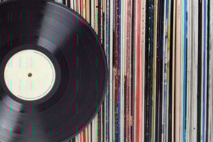 A vinyl record and a collection of record sleeves 