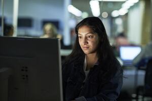 A person sitting at a desk using a computer